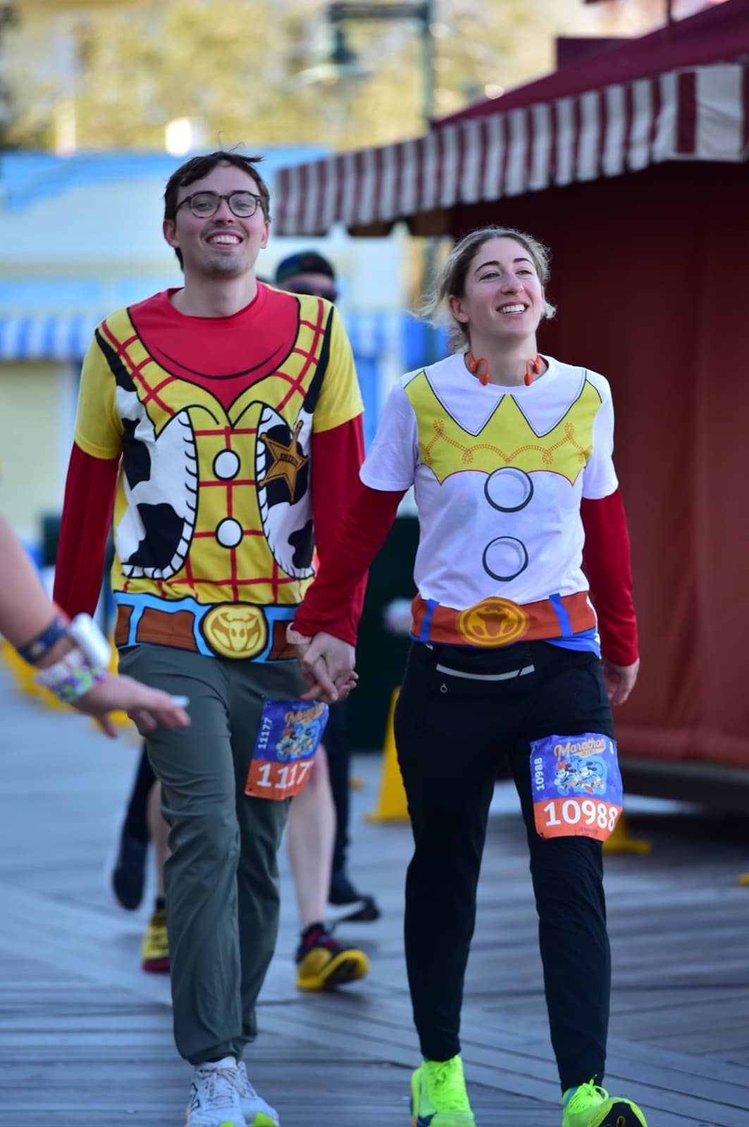 Jen and Luke running a race dressed as Woody and Jessie